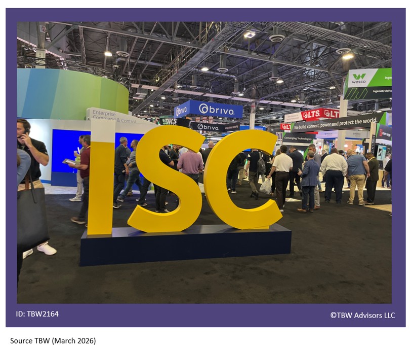 Yellow 6 foot high letters that say I S C in the front of the expo hall so many people and exhibits in background