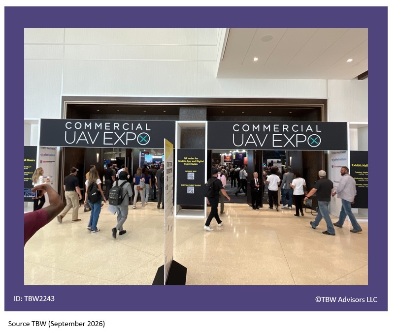 Entrance to CUAV Expo Hall with Commercial UAV Expo sign with logo above each double door. People moving about.