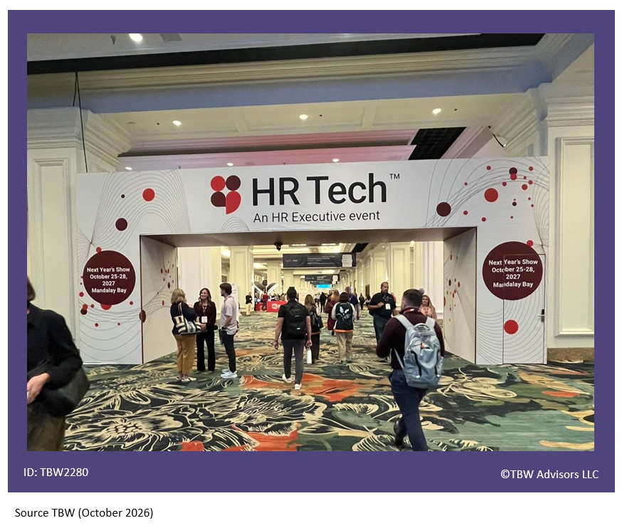 HR Tech with logo in a white walk through bridge exit to expo hall with attendees gathered throughout.